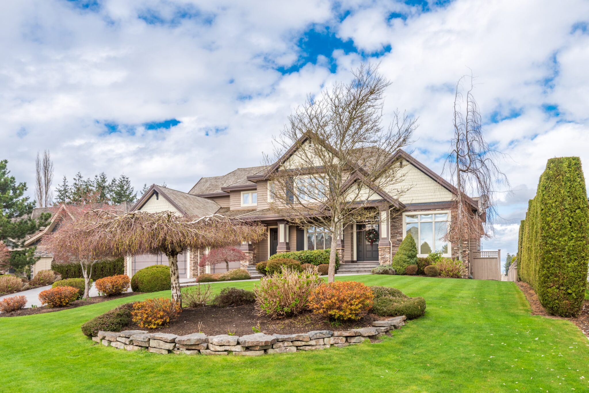 Exterior of a newly built home with siding, stone veneer and a shingle roof